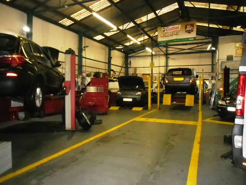 Cars being maintained in the G and J Starkey workshop