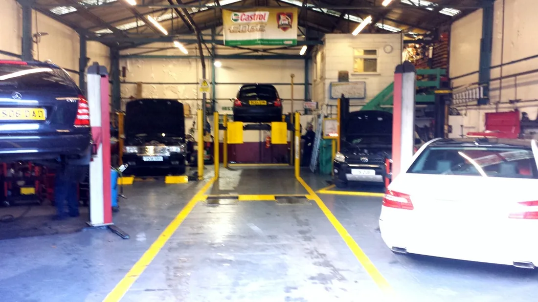 Vehicles on workshop lifts in the garage